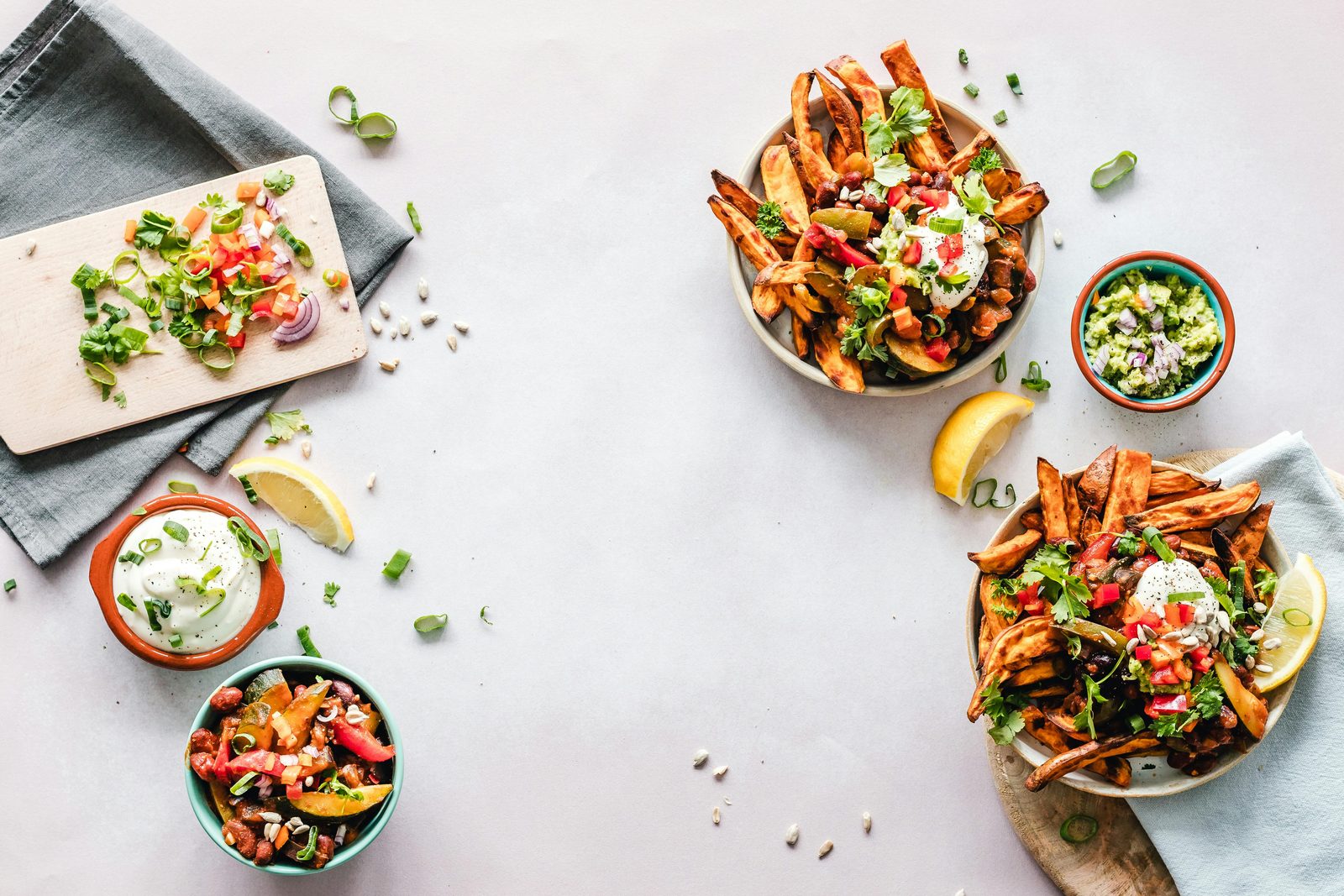 Colorful seasonal bowls with roasted vegetables, herbs, and fresh garnishes